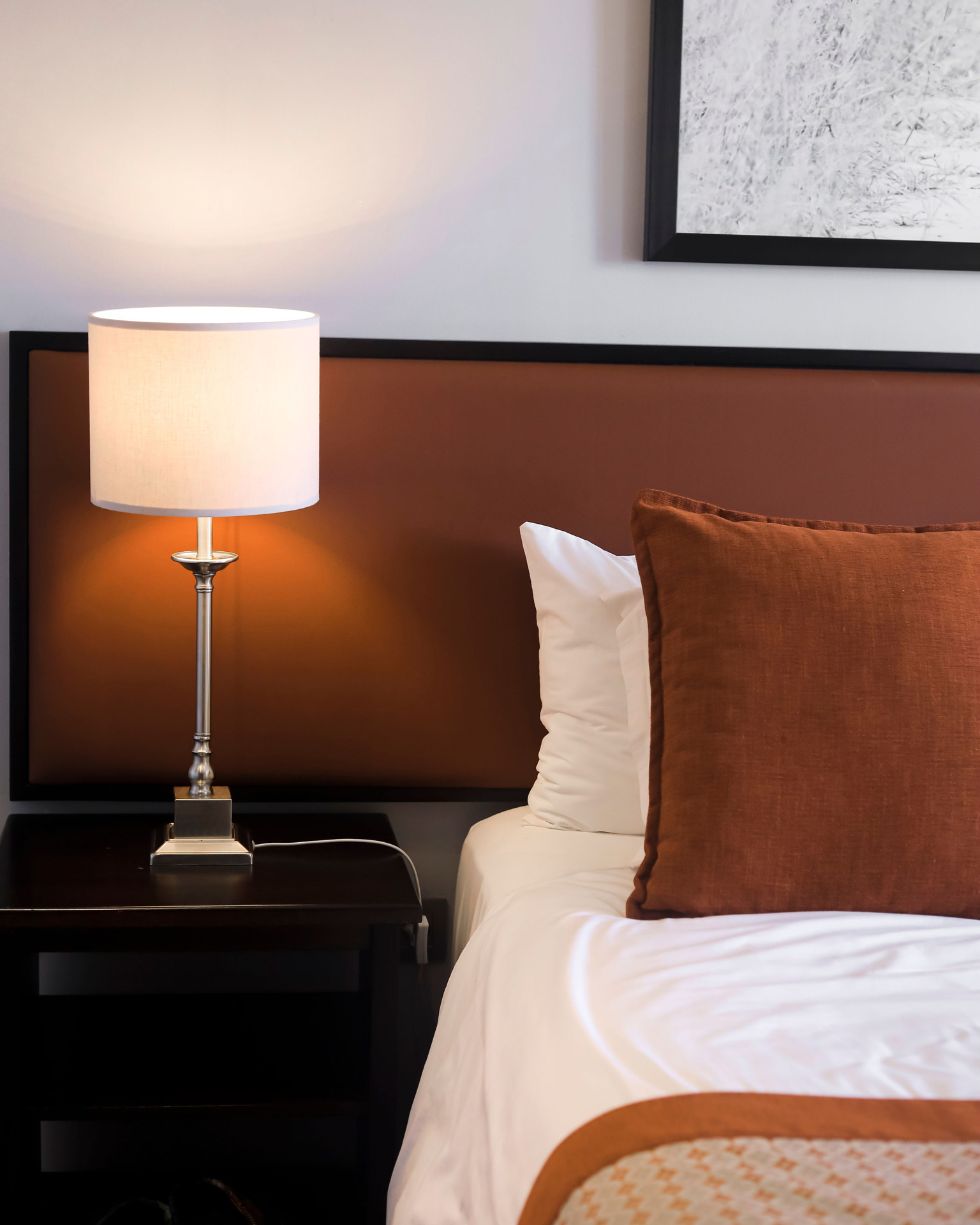Family Junior Suite with cosy bed and bedside lamp at SALT of Akagera.
