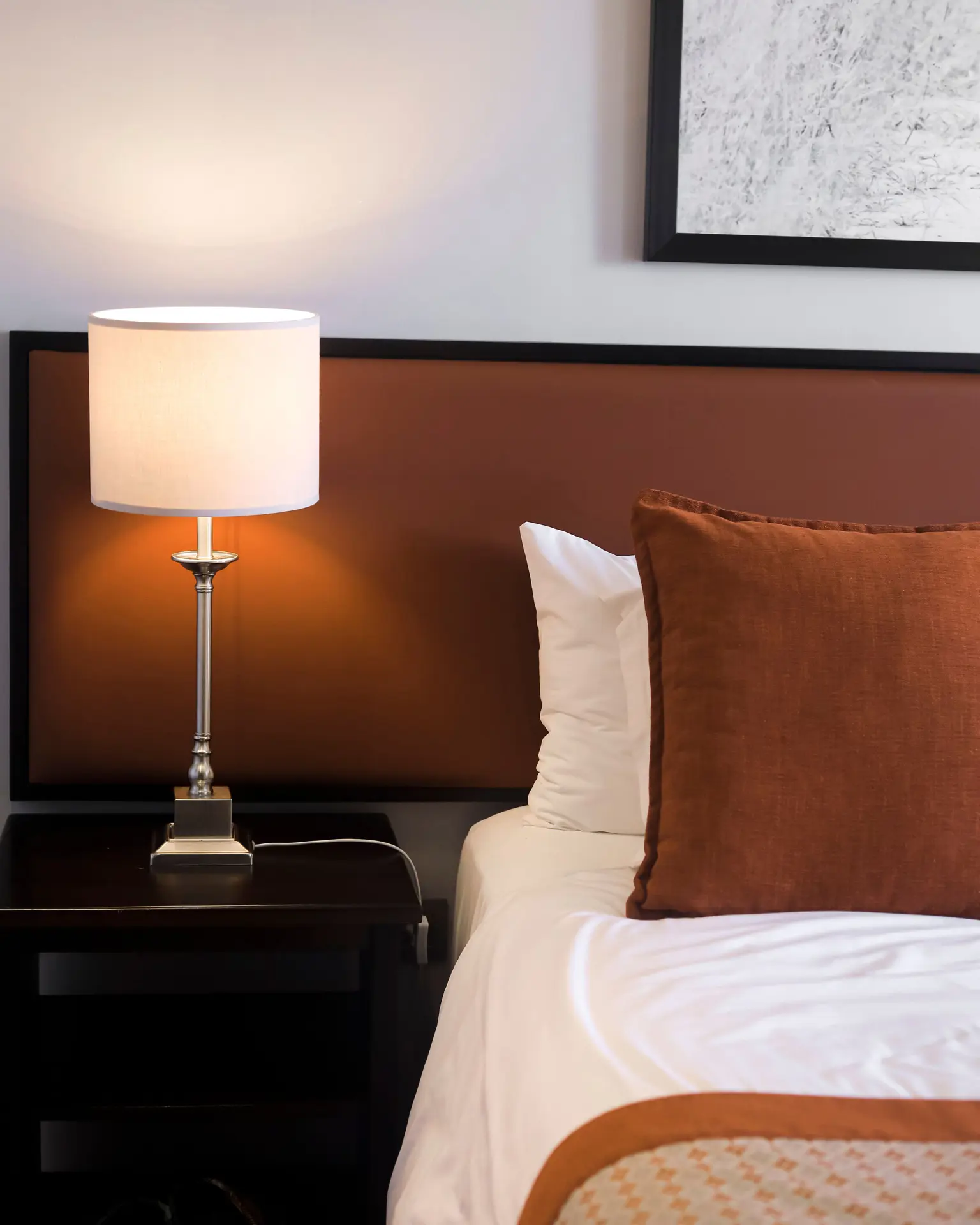 Family Junior Suite with cosy bed and bedside lamp at SALT of Akagera.