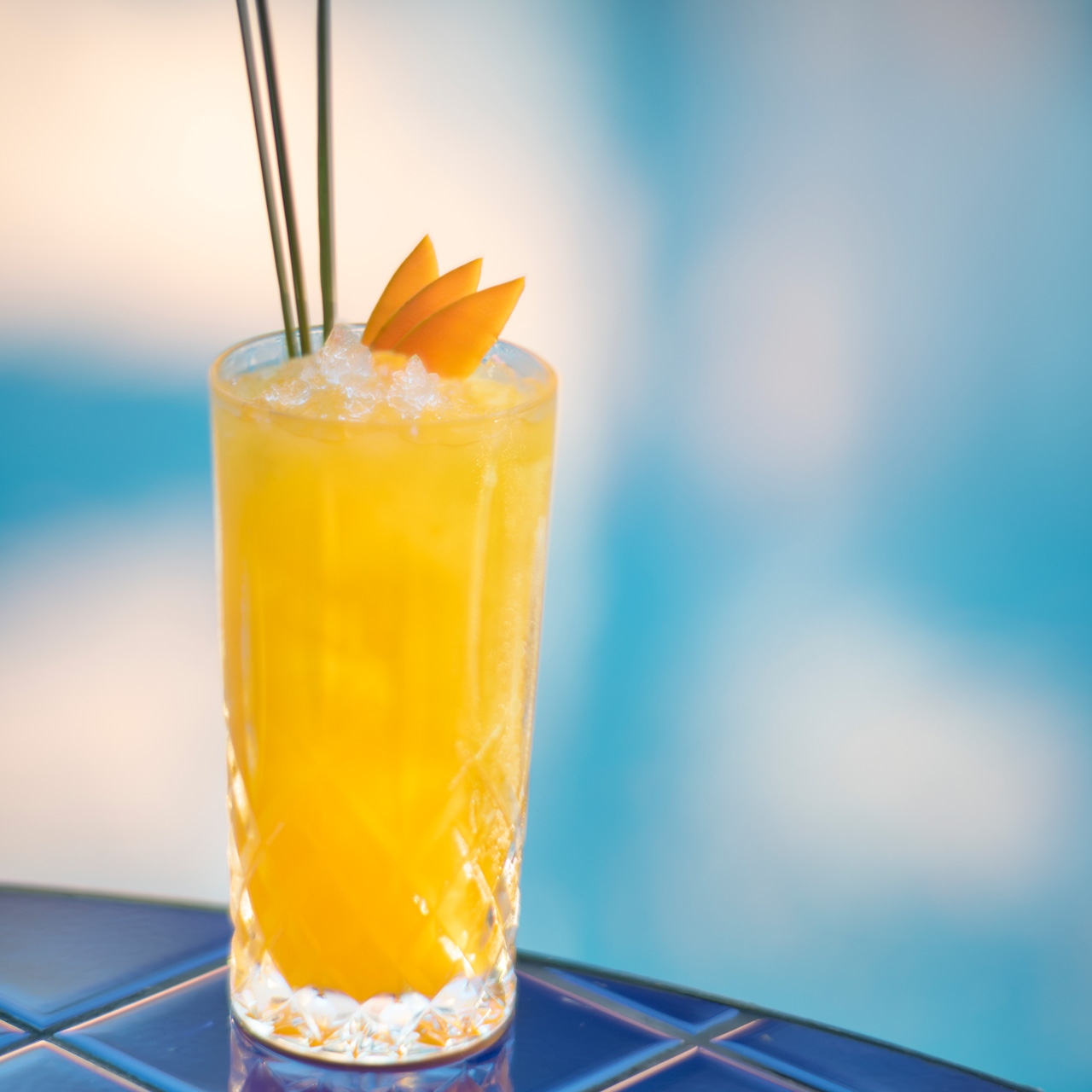 Refreshing mango and lemongrass cocktail served over crushed ice.