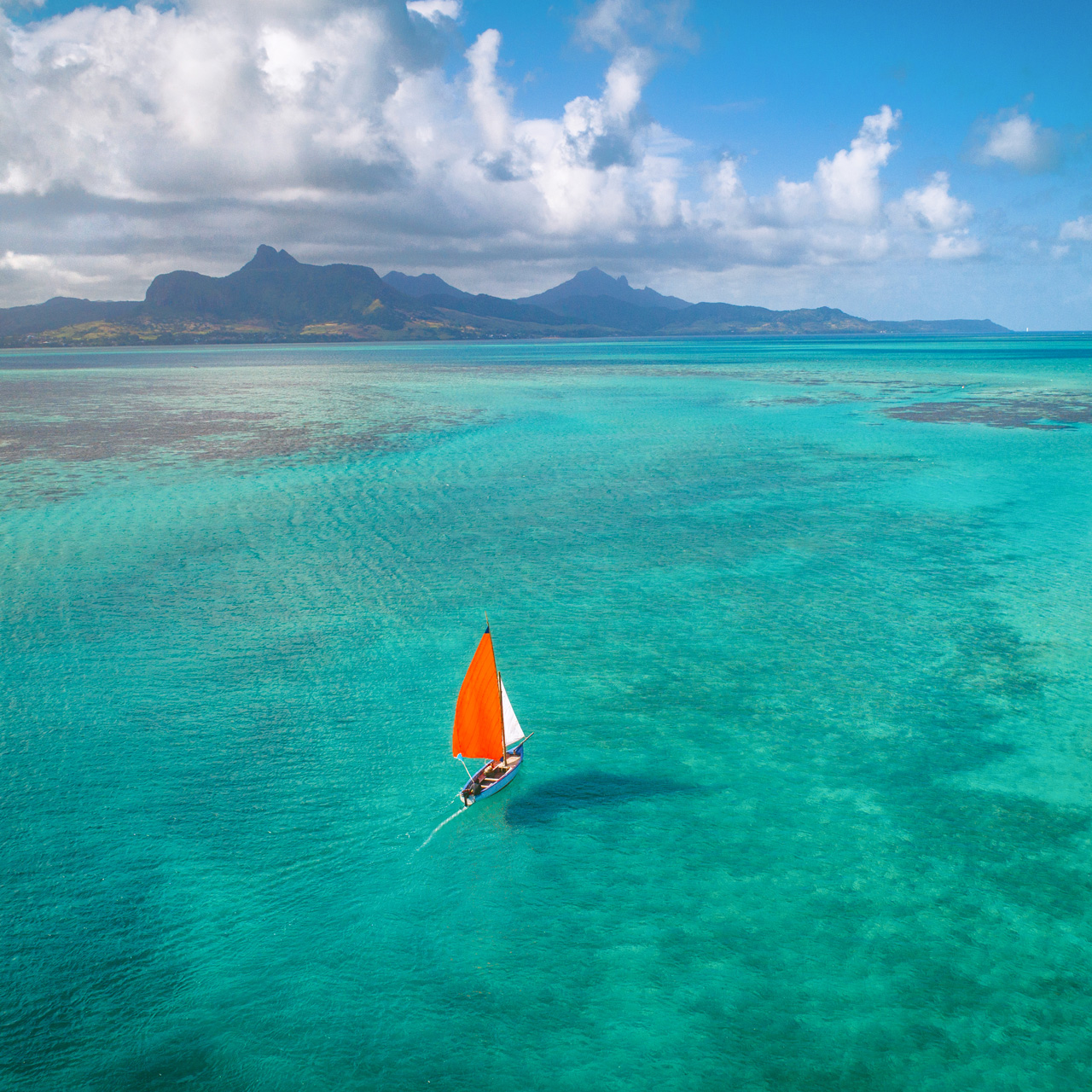 Traditional sailing boat on the turquoise lagoon of Mauritius.