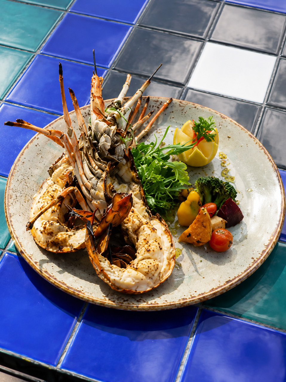 Grilled lobster served with seasonal vegetables and fresh lemon.