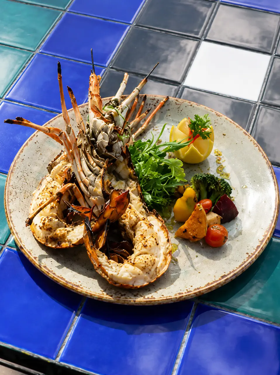 Grilled lobster served with seasonal vegetables and fresh lemon.