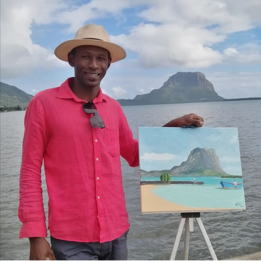 Artist Dani Volbert presenting one of his island-inspired paintings.