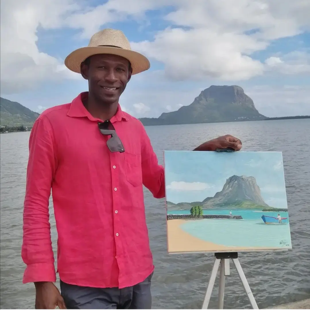 Artist Dani Volbert presenting one of his island-inspired paintings.