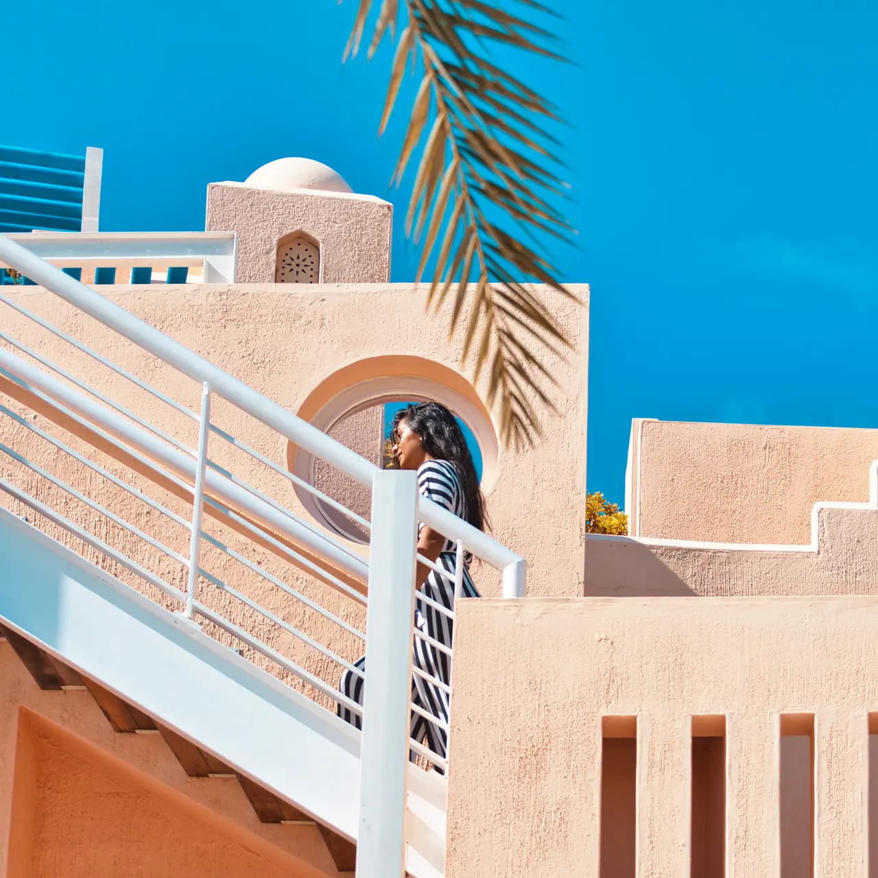 Guest walking through the pastel architecture of SALT of Palmar.