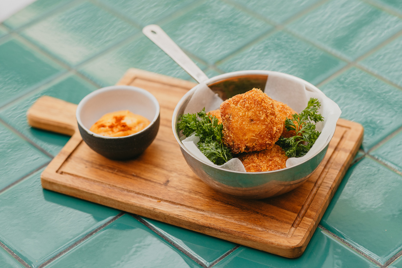 Crispy shrimp croquettes with dipping sauce.