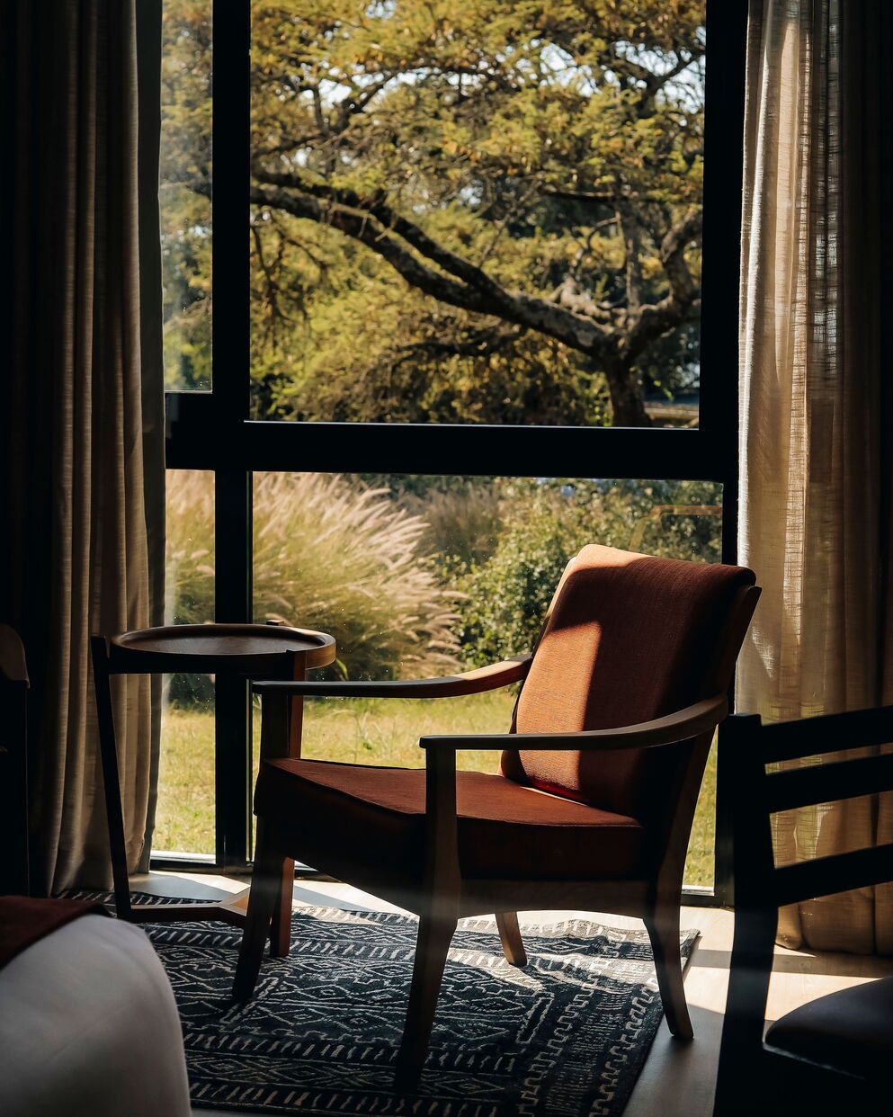 Seating area with garden views at SALT of Akagera.