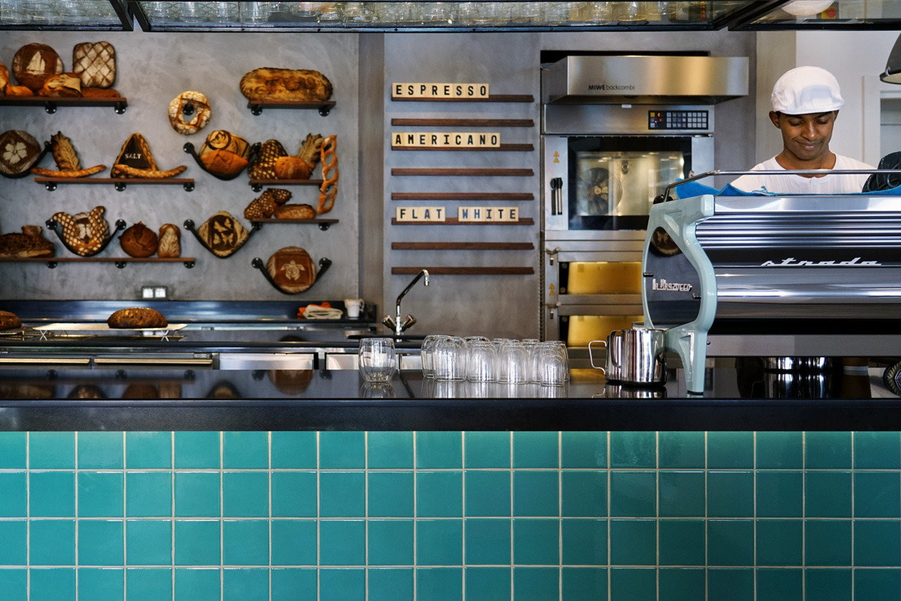 Coffee counter with artisan breads on display.
