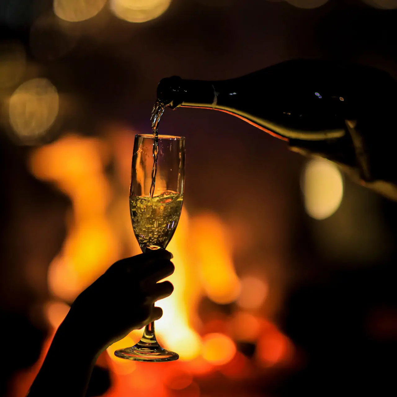 Sparkling wine poured by the fire at SALT of Akagera.