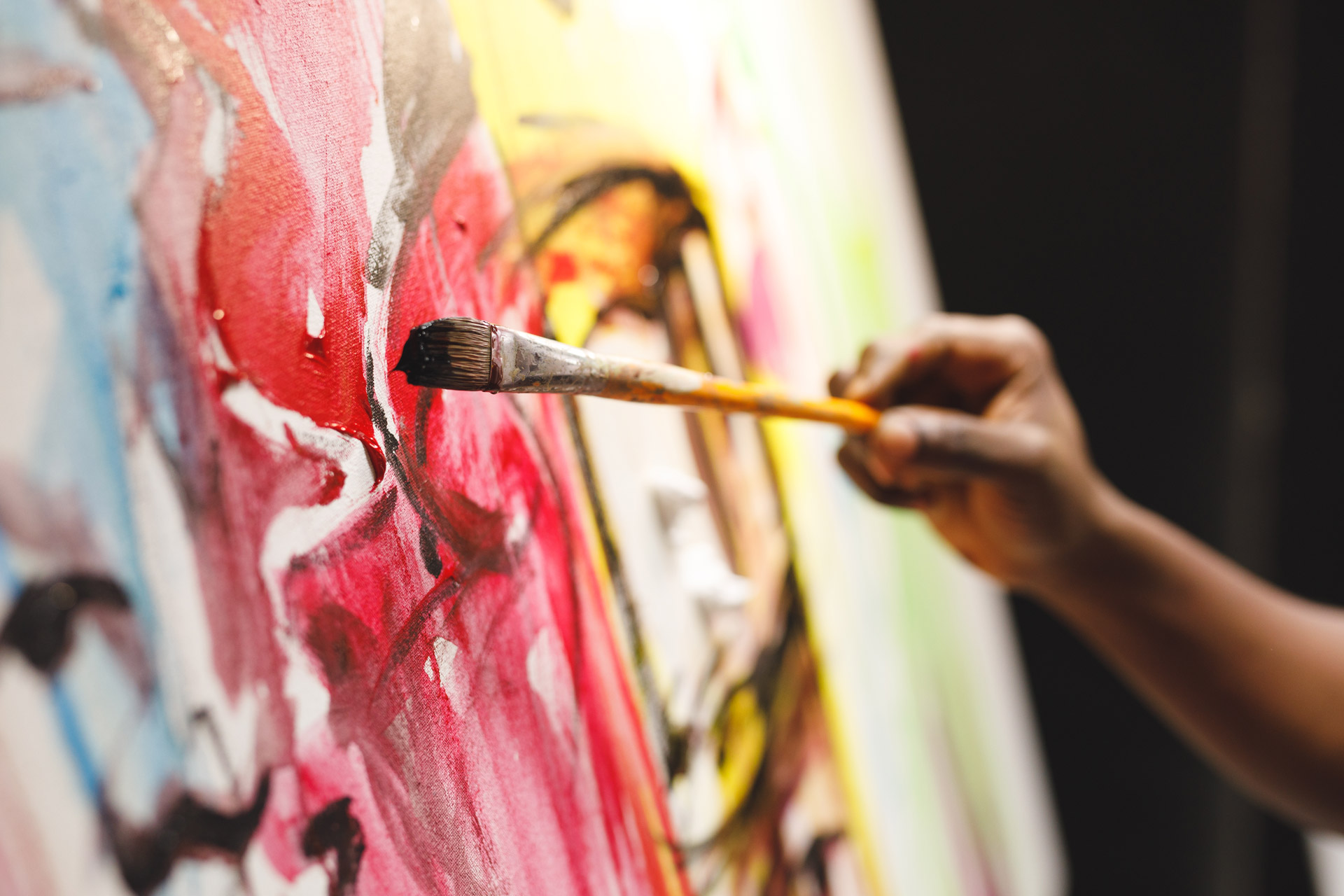 Local artist adding vibrant colours to a canvas.