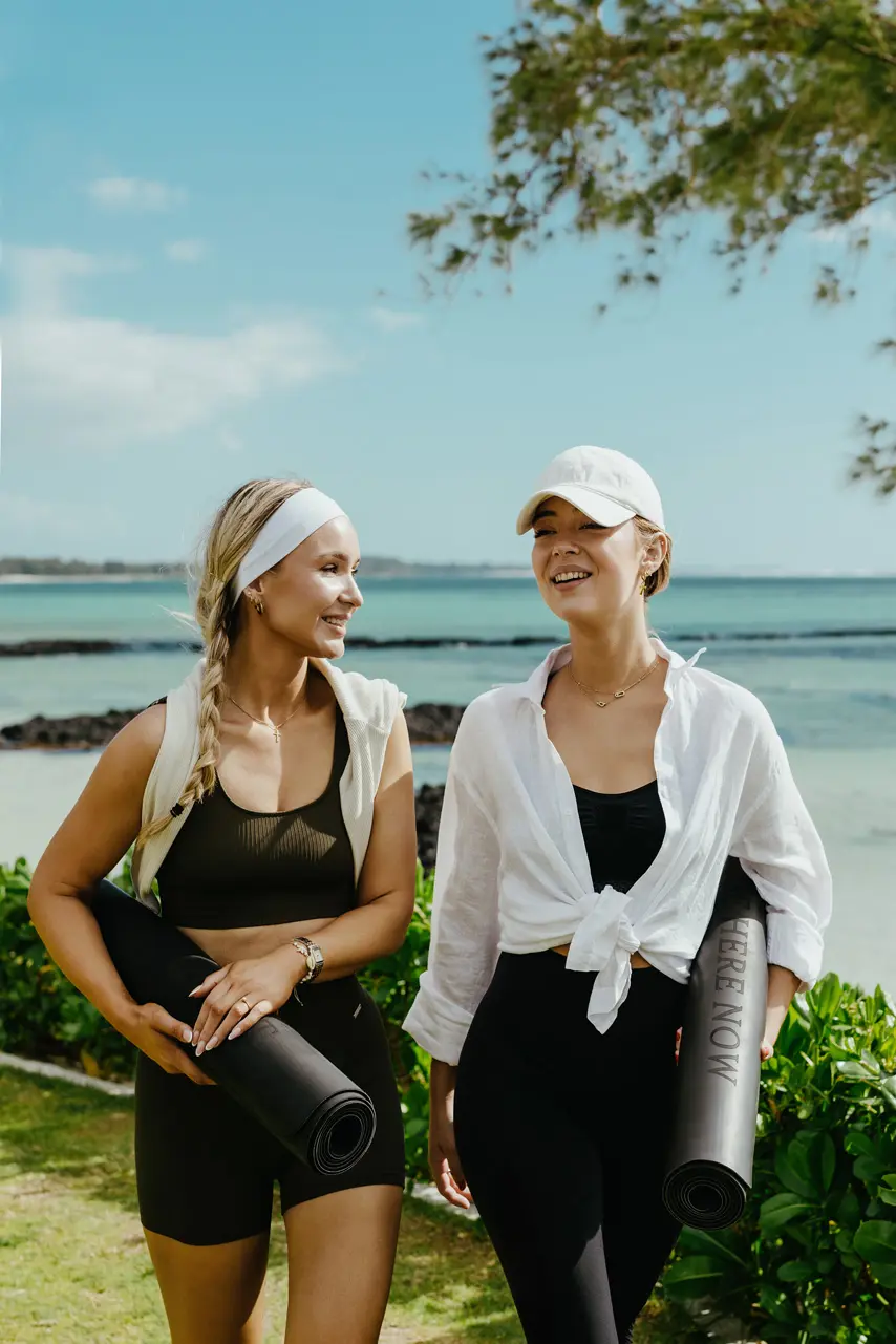 Guests walking to a yoga session by the sea.