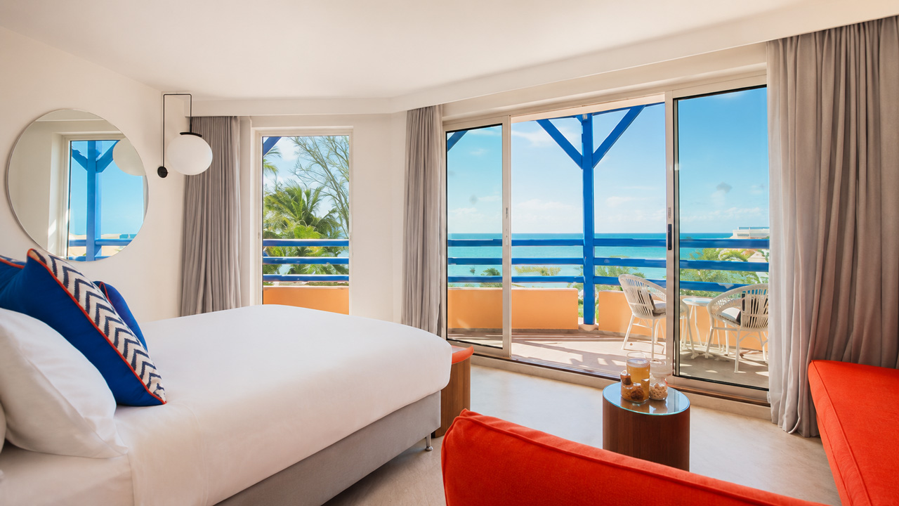 Spacious bedroom with balcony and sea view.