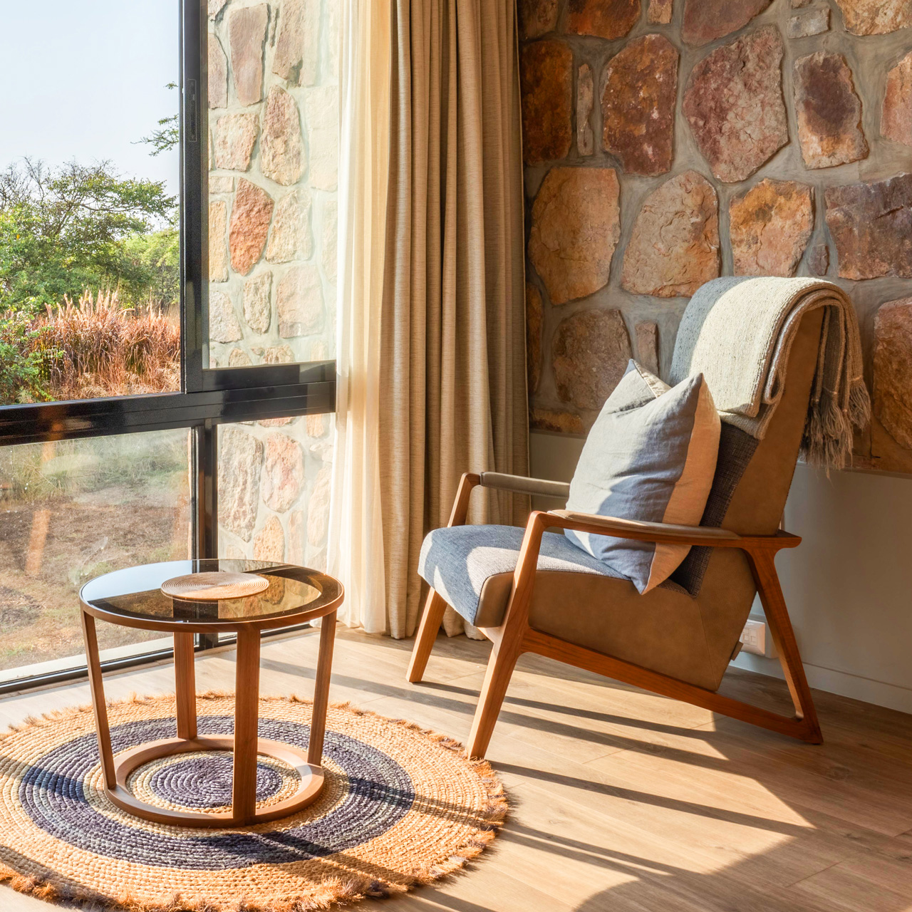 Cozy lounge corner in the Akagera Grand Suite with savannah views.