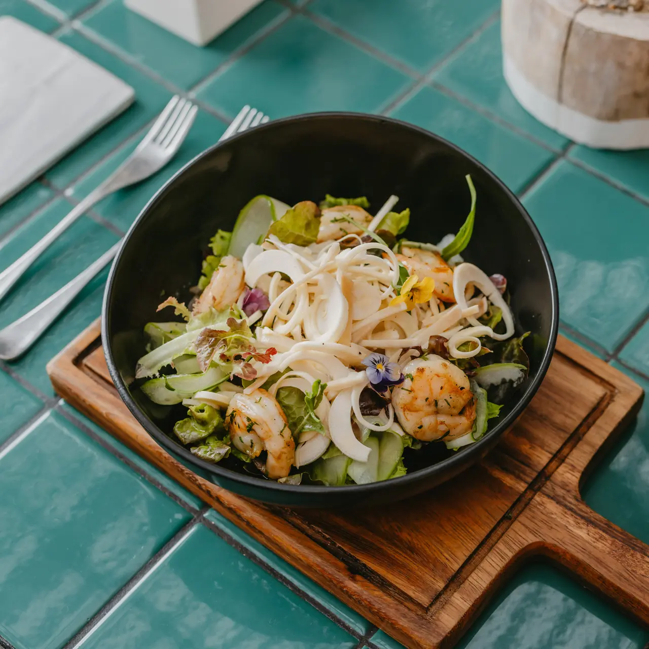 Grilled shrimp salad with fresh vegetables and shaved palm heart.
