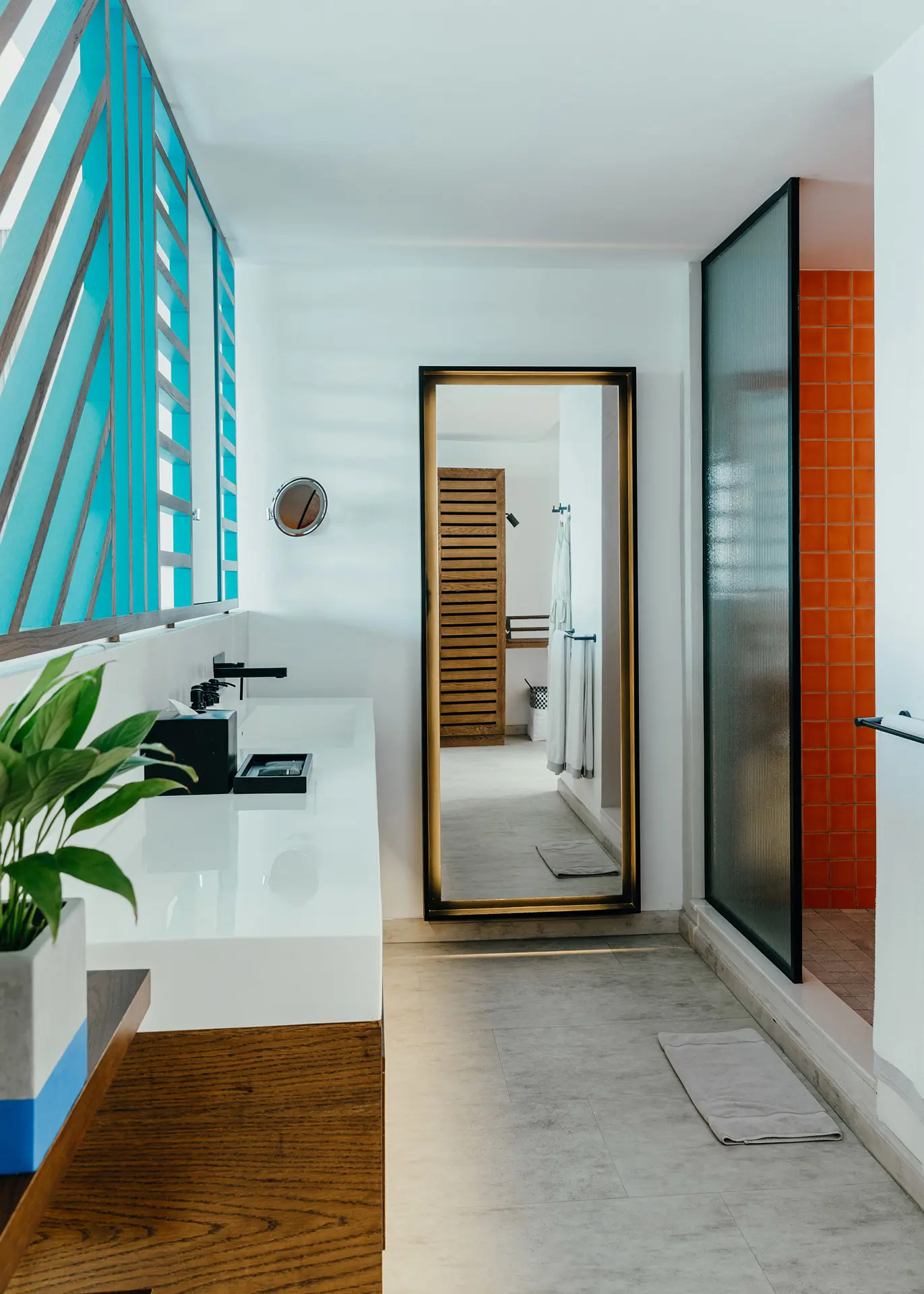 Bright bathroom with a spacious vanity, rainfall shower, and modern design details.