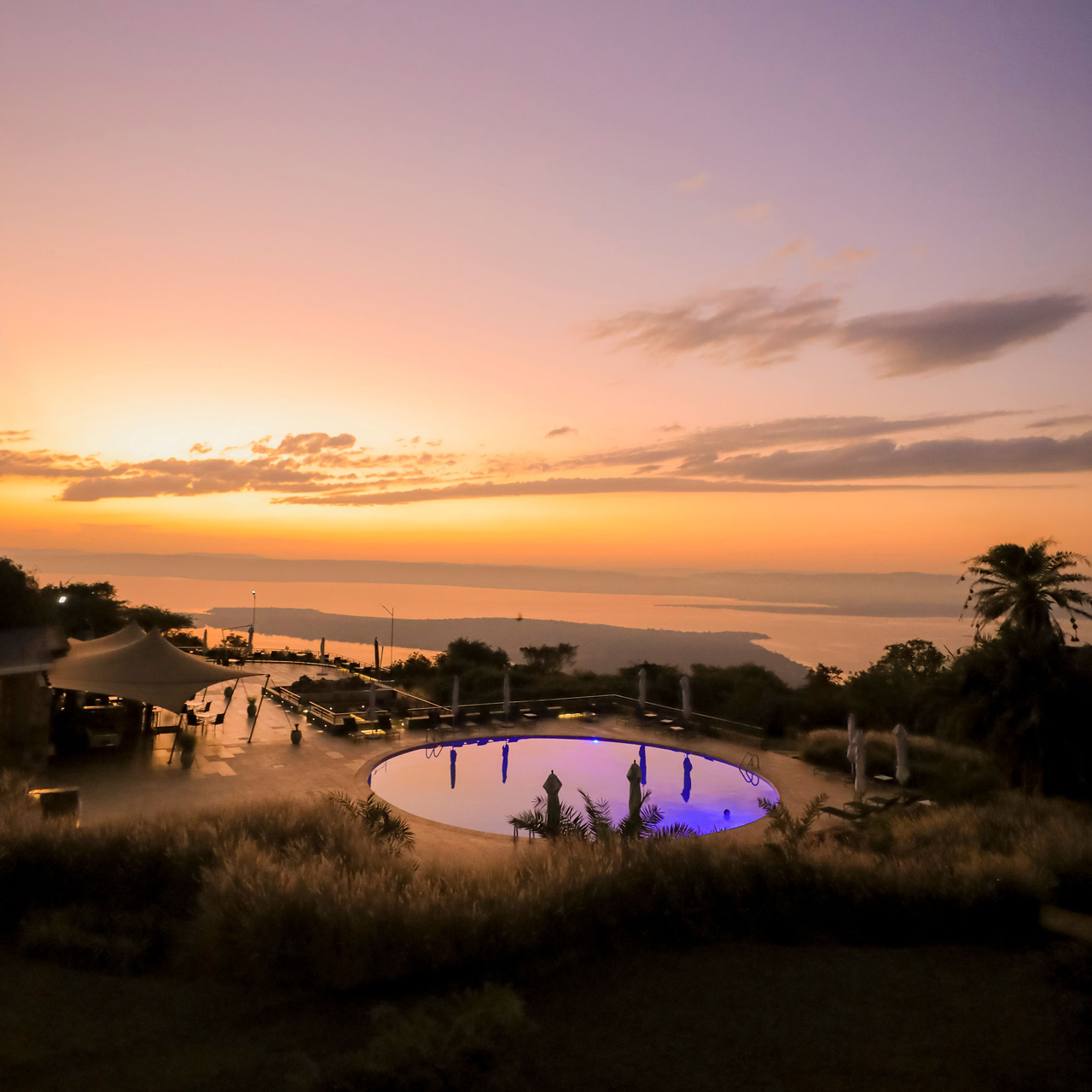 Sunset over the pool and Lake Ihema at SALT of Akagera.