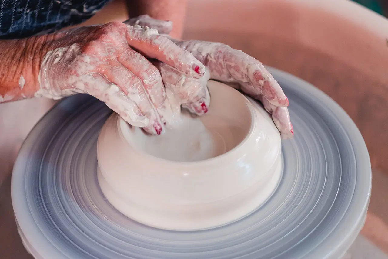 Shaping a handcrafted ceramic bowl on a pottery wheel.