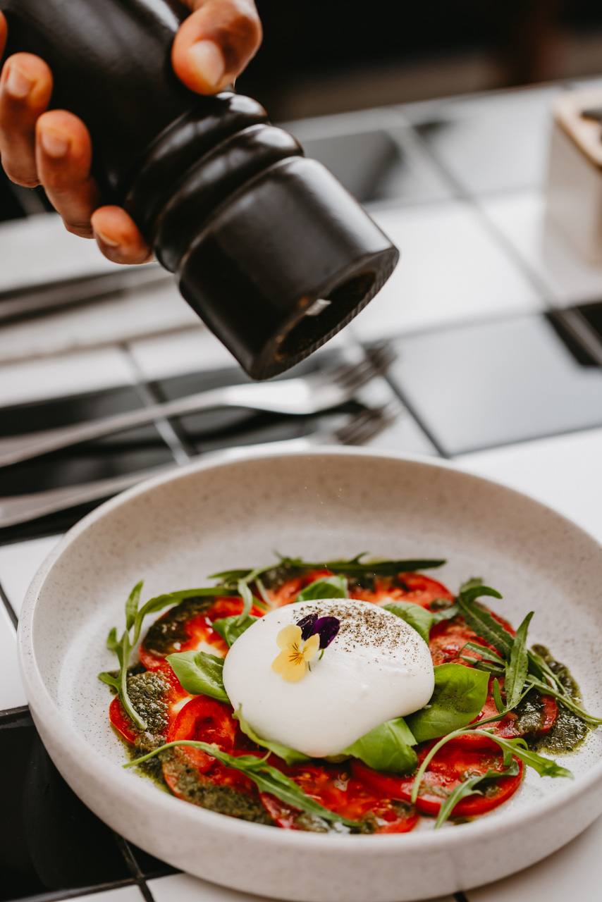 Garden tomato burrata salad with fresh basil.