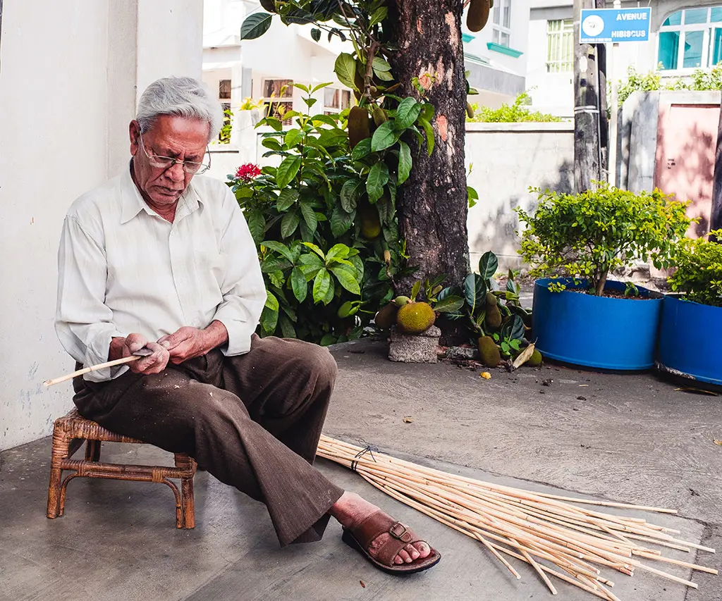 Rattan craftsman Moosbally weaving by hand.